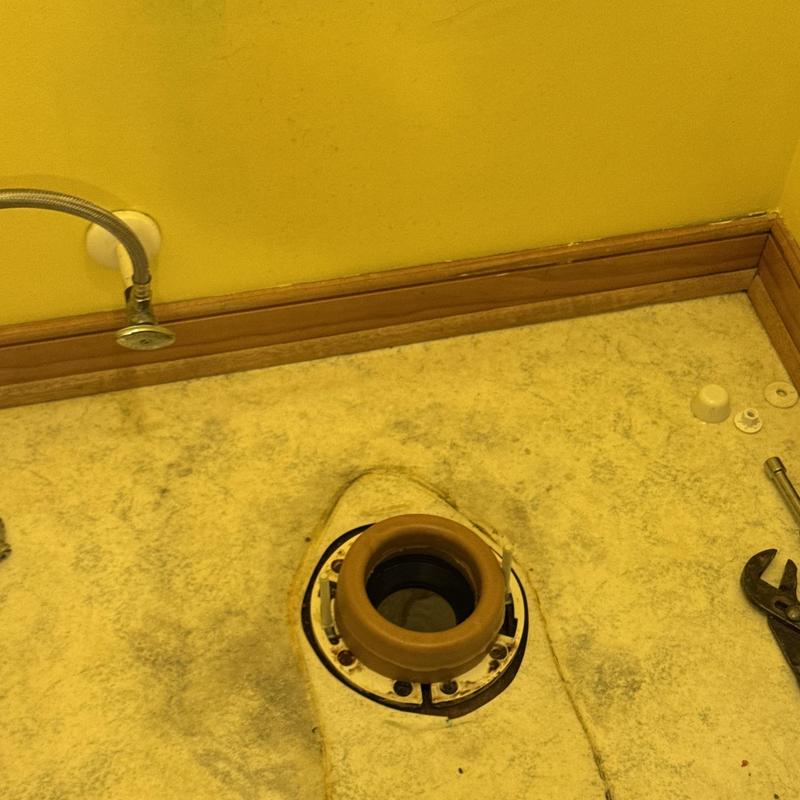 Toilet flange on bathroom floor with exposed plumbing Toilet flange on bathroom floor with exposed plumbing