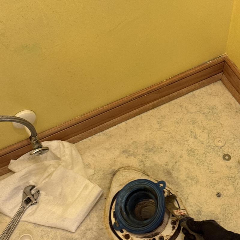 Toilet flange installation with wrench and sealant nearby Toilet flange installation with wrench and sealant nearby