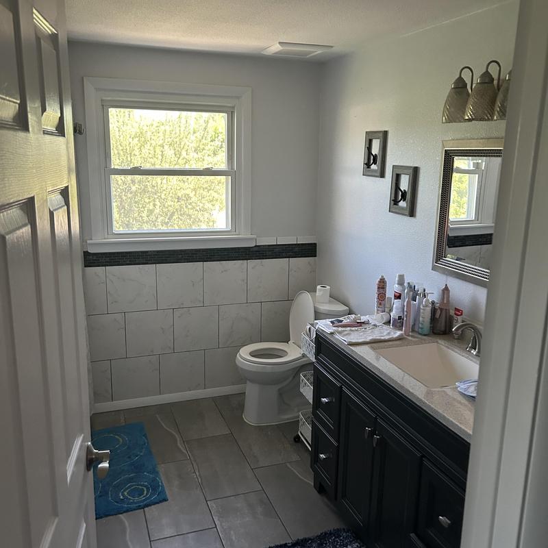 Bathroom exhaust fan installation in tiled bathroom