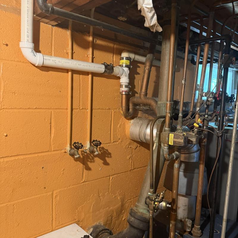 Water supply valves and piping in basement utility area Water supply valves and piping in basement utility area