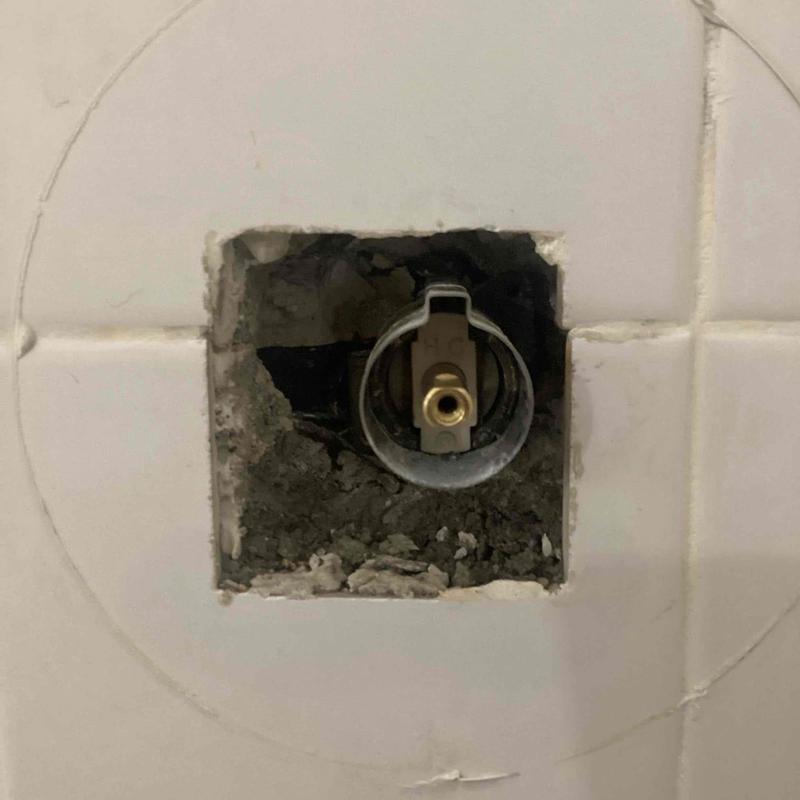 Shower valve cartridge installation in tiled wall opening