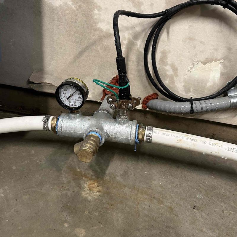 Water pressure gauge and valve assembly on pipe