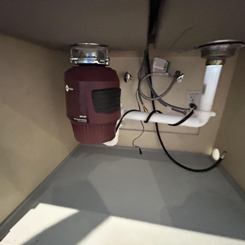 Garbage disposal unit installed under kitchen sink