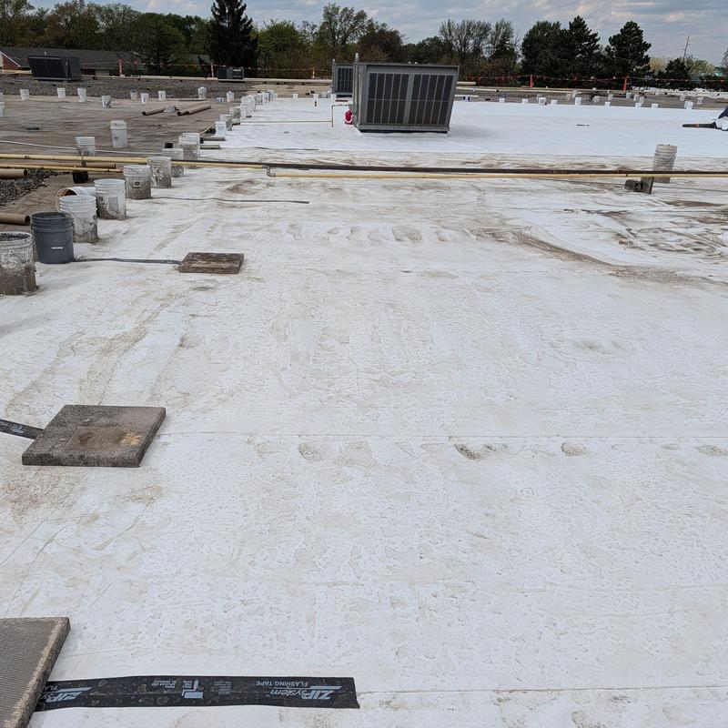 TPO single ply roof with HVAC unit and vent pipes