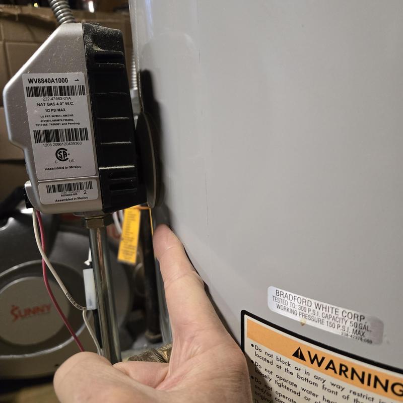 50-Gallon natural gas water heater installation close-up 50-Gallon natural gas water heater installation close-up