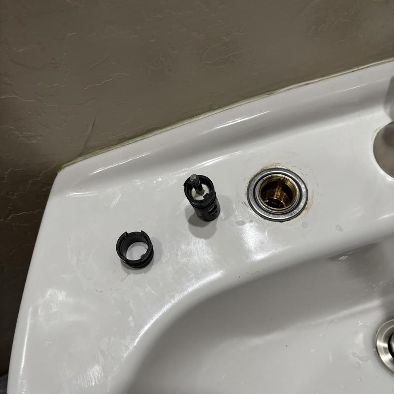 Moen two-handle bathroom faucet cartridge parts on sink Moen two-handle bathroom faucet cartridge parts on sink