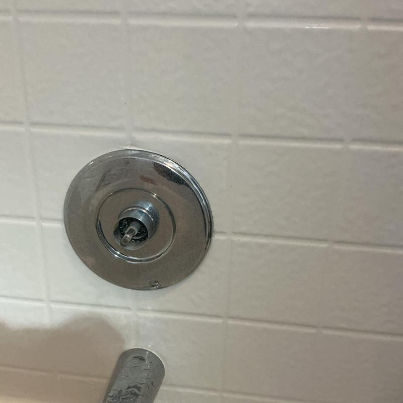 Shower valve with removed cartridge in tiled wall
