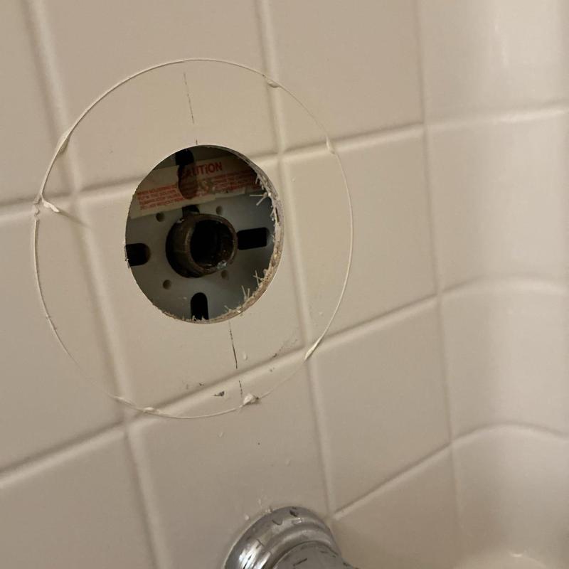 Shower cartridge housing in tiled shower wall