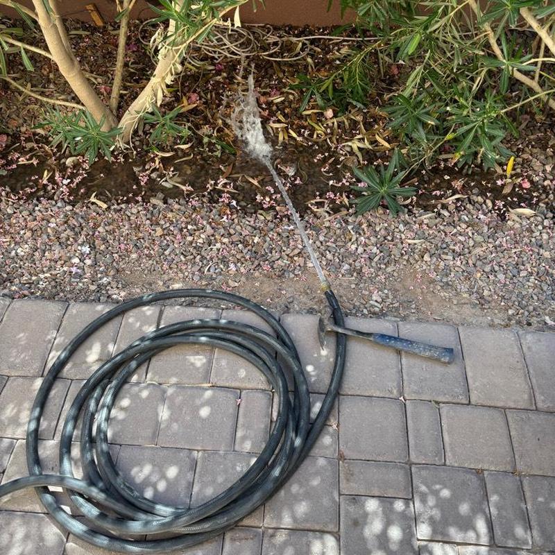 Pressure relief valve water discharge with hose on ground