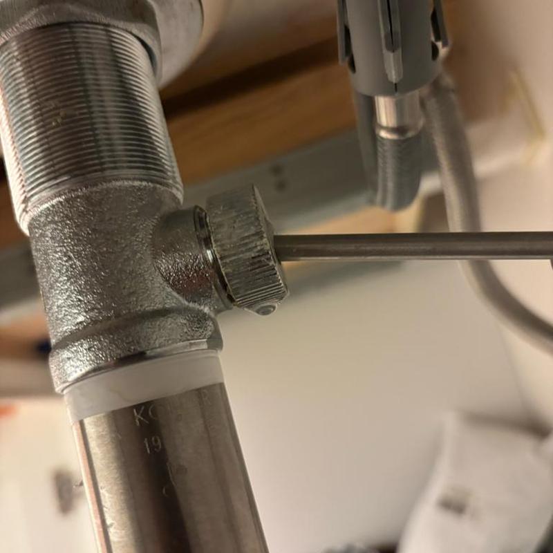 Bathroom sink drain pop-up rod adjustment under sink