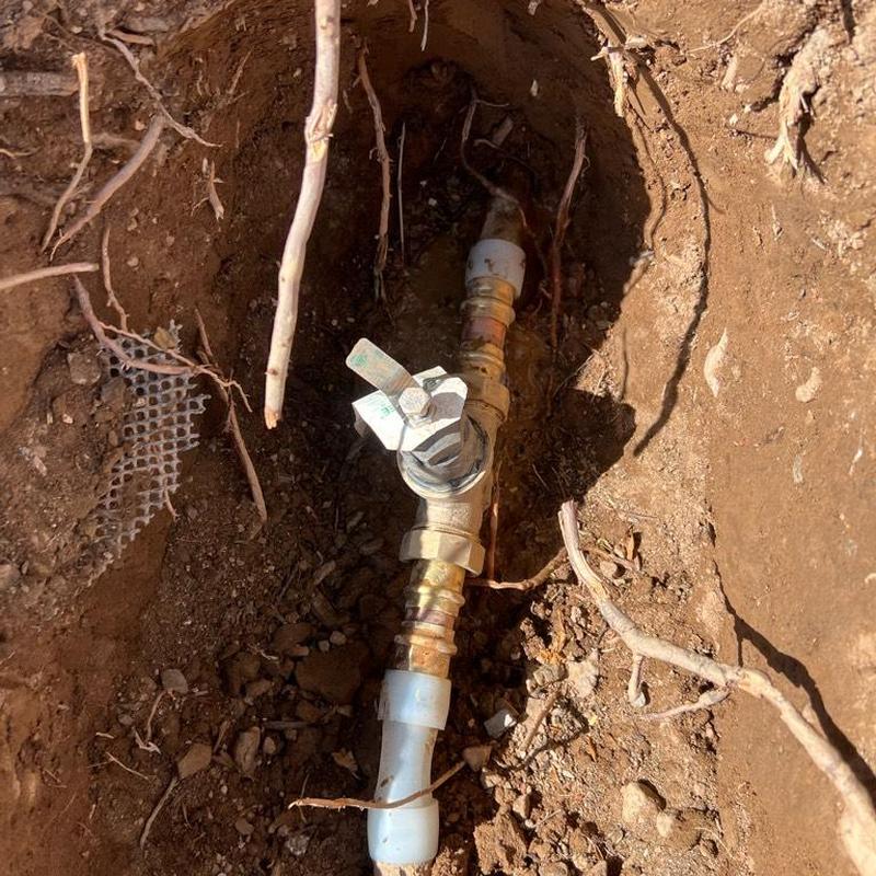 Main water line valve installation in dirt trench