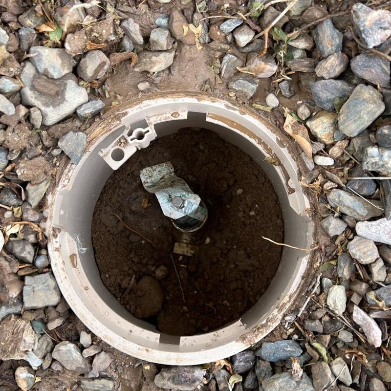 Pressure regulator valve in protective landscaping box