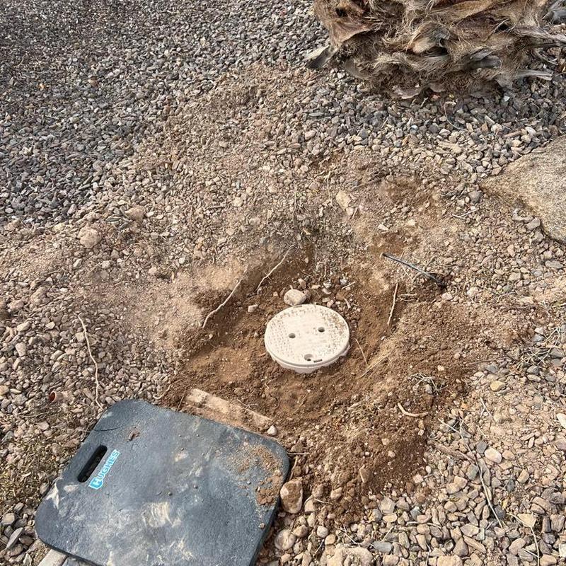 Main water line valve access box in rocky soil area