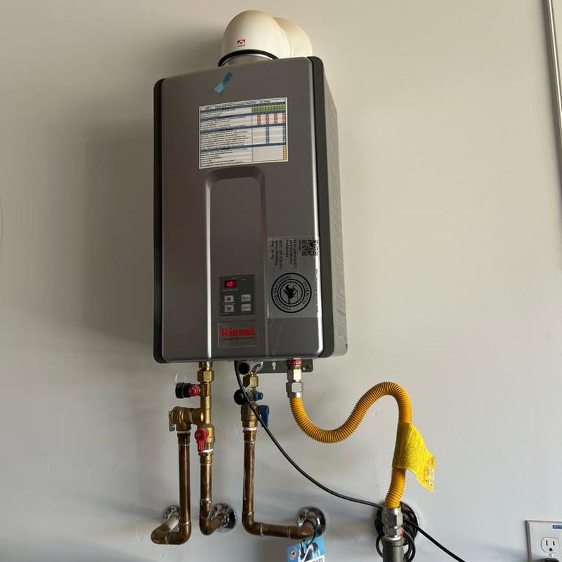 Tankless water heater with connected pipes and tubing