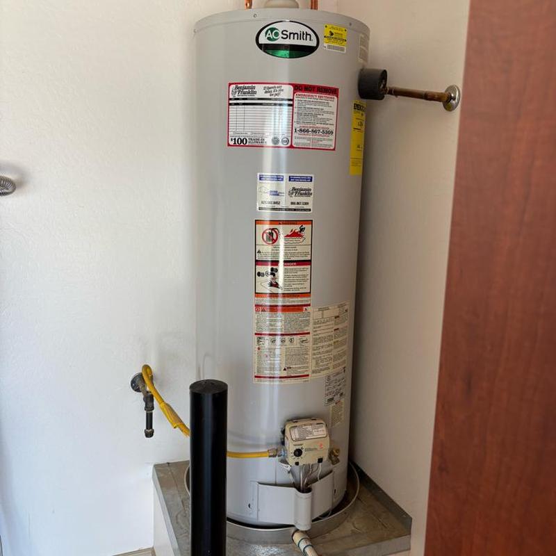 Gas water heater installed on raised metal platform