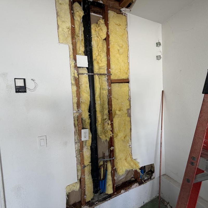 Copper water line with repair couplings behind drywall