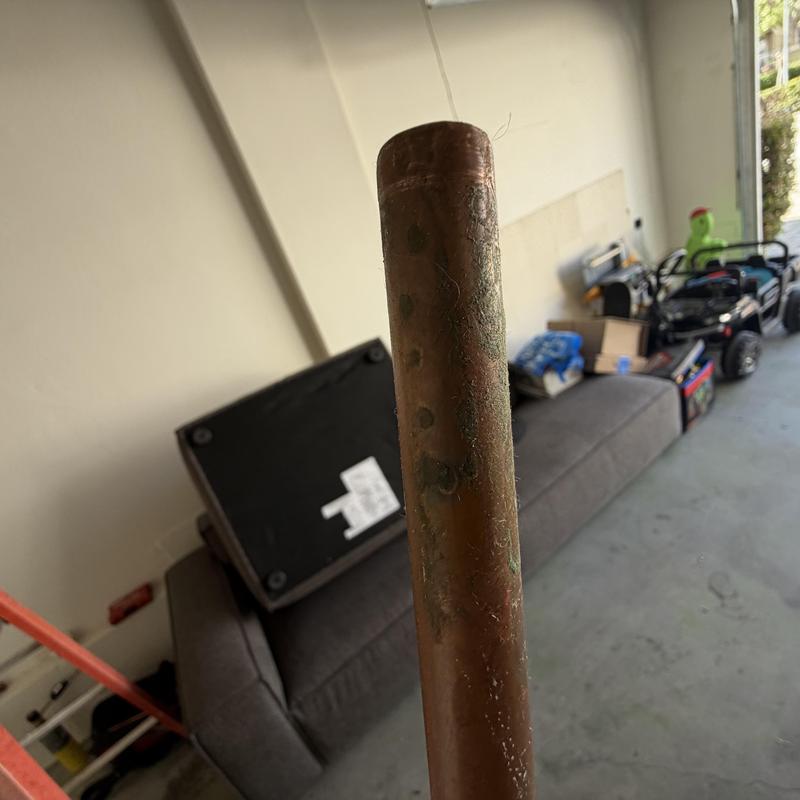 Copper water line with pinhole leak before repair
