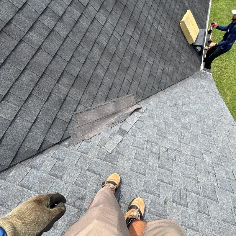 Asphalt shingle roof with damaged flashing near valley