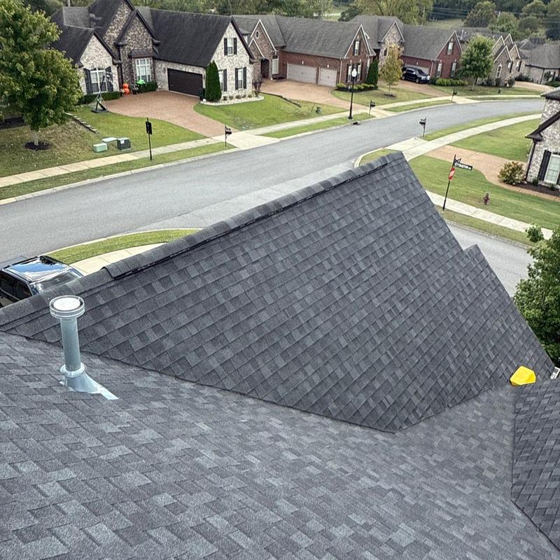 Asphalt shingle roof inspection in suburban neighborhood