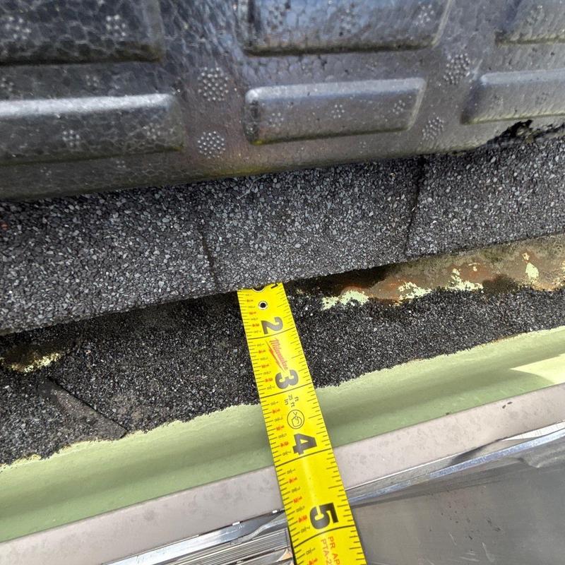 Roof shingle edge with measurement tape for inspection