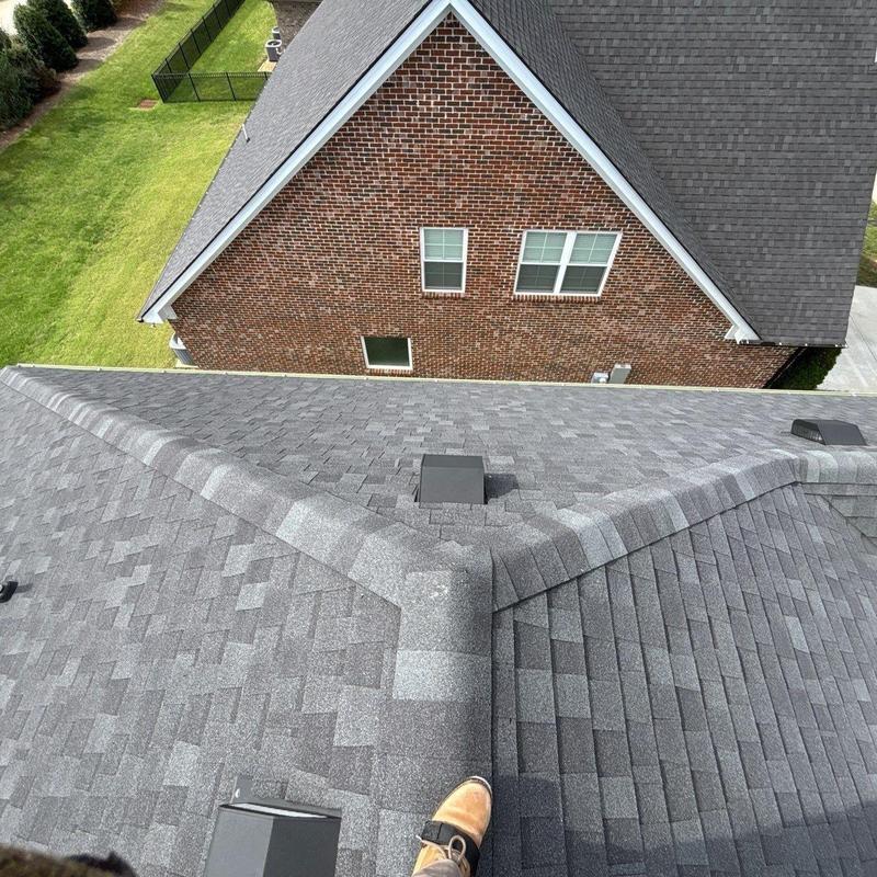 Asphalt shingle roof inspection showing ridge and vents
