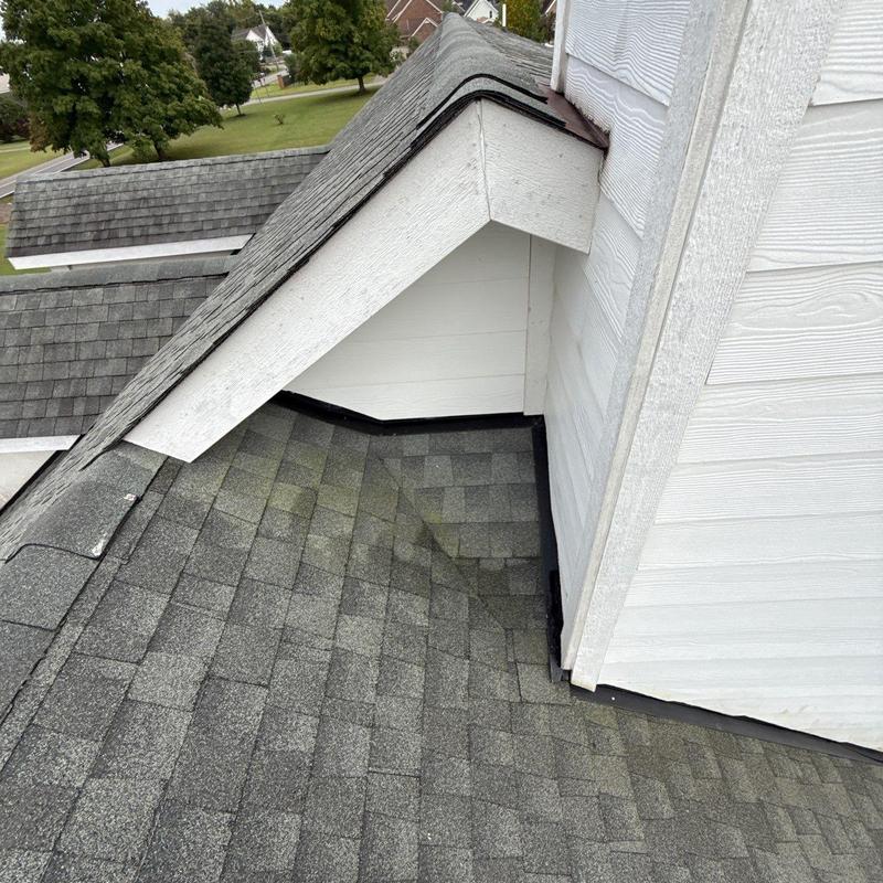 Roof flashing and shingle inspection on dormer roof section