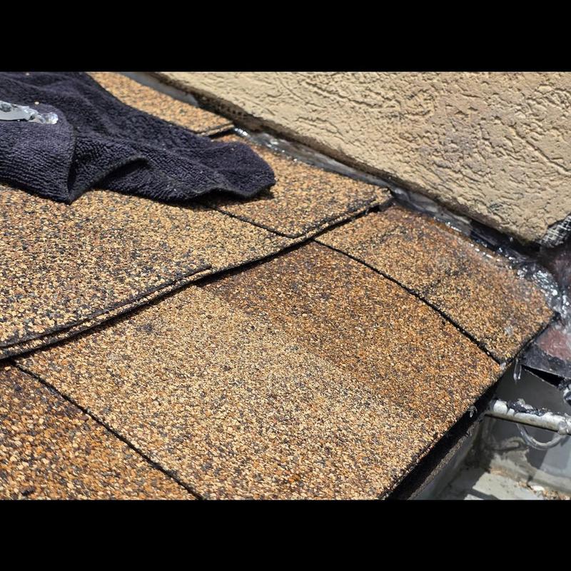 Asphalt shingle roof edge repair near stucco wall Asphalt shingle roof edge repair near stucco wall