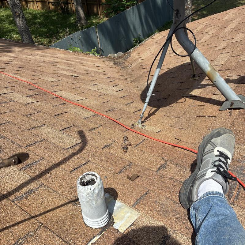 Roof plumbing vent pipe with worn flashing on shingle roof