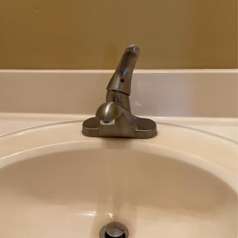 Bathroom sink faucet with single handle on white basin Bathroom sink faucet with single handle on white basin