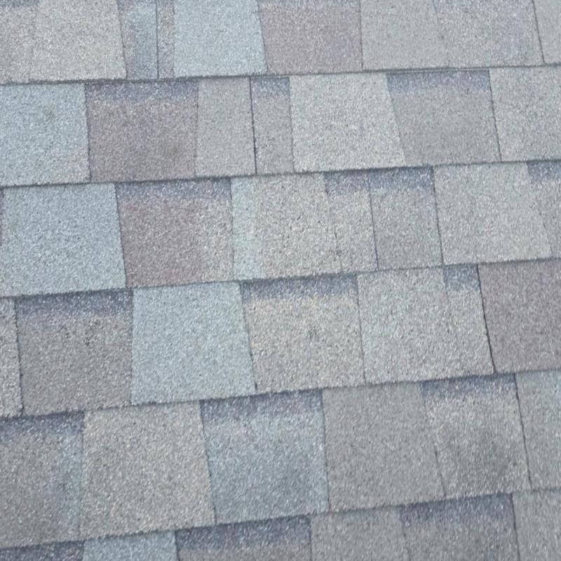 Asphalt shingles with hail damage and granule loss Asphalt shingles with hail damage and granule loss