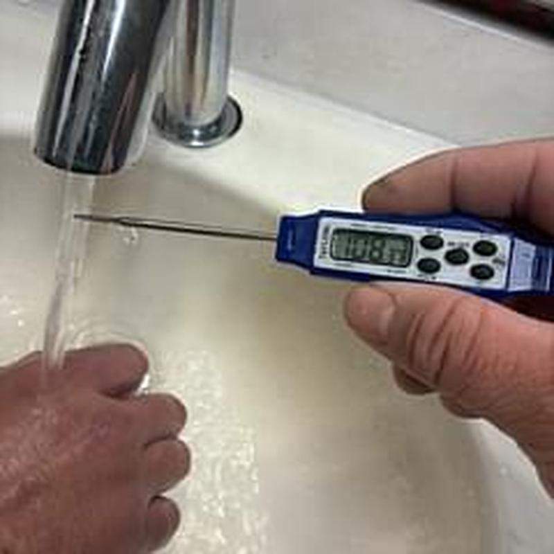 Faucet water temperature test with digital thermometer