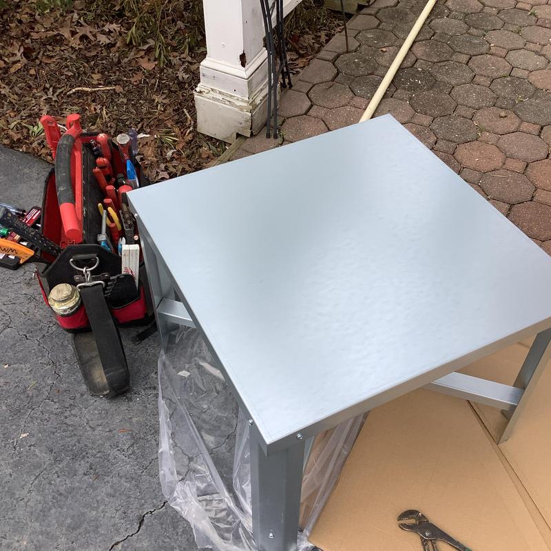 Electric water heater stand with plumbing tools nearby Electric water heater stand with plumbing tools nearby