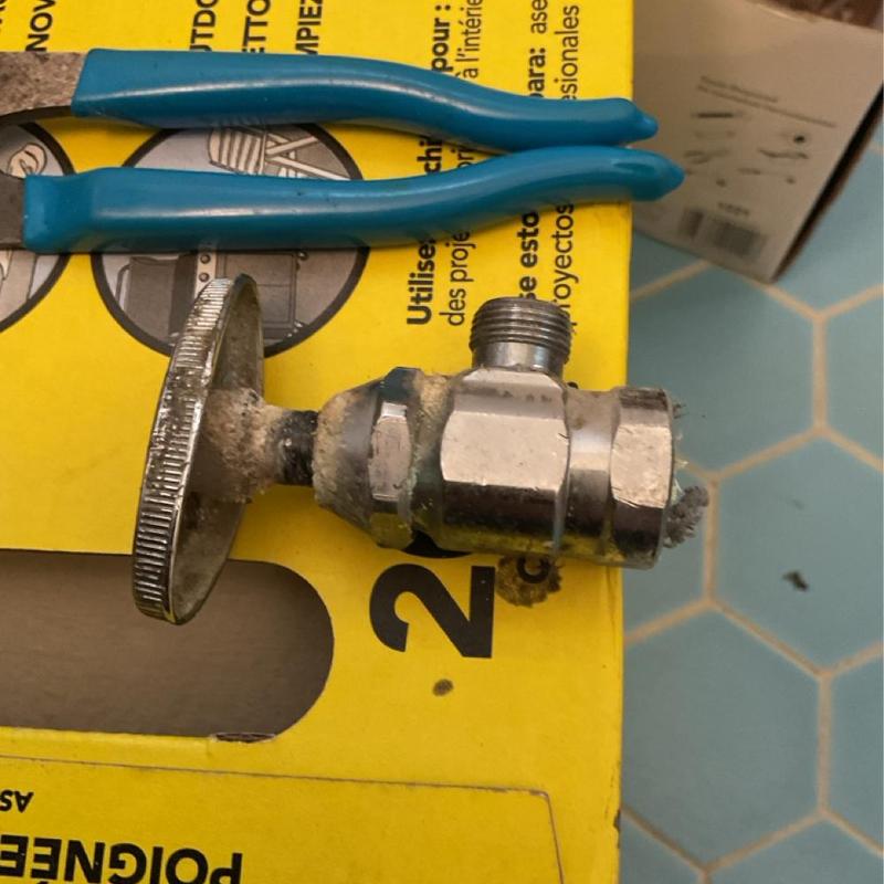 Bathroom sink shut-off valve with corrosion and pliers Bathroom sink shut-off valve with corrosion and pliers