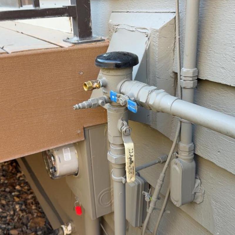 Vacuum breaker and spigot with valves on exterior wall