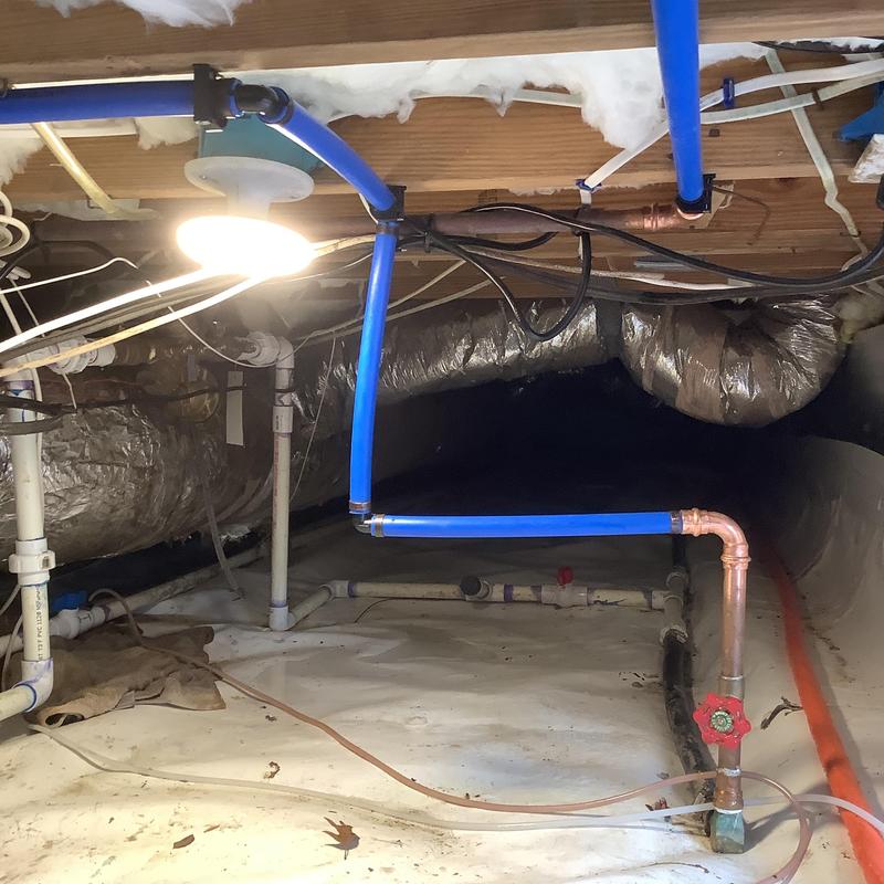 Blue PEX water supply piping with copper fittings in crawl space Blue PEX water supply piping with copper fittings in crawl space