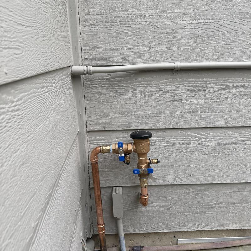 Vacuum breaker pipe and fitting installation outside wall