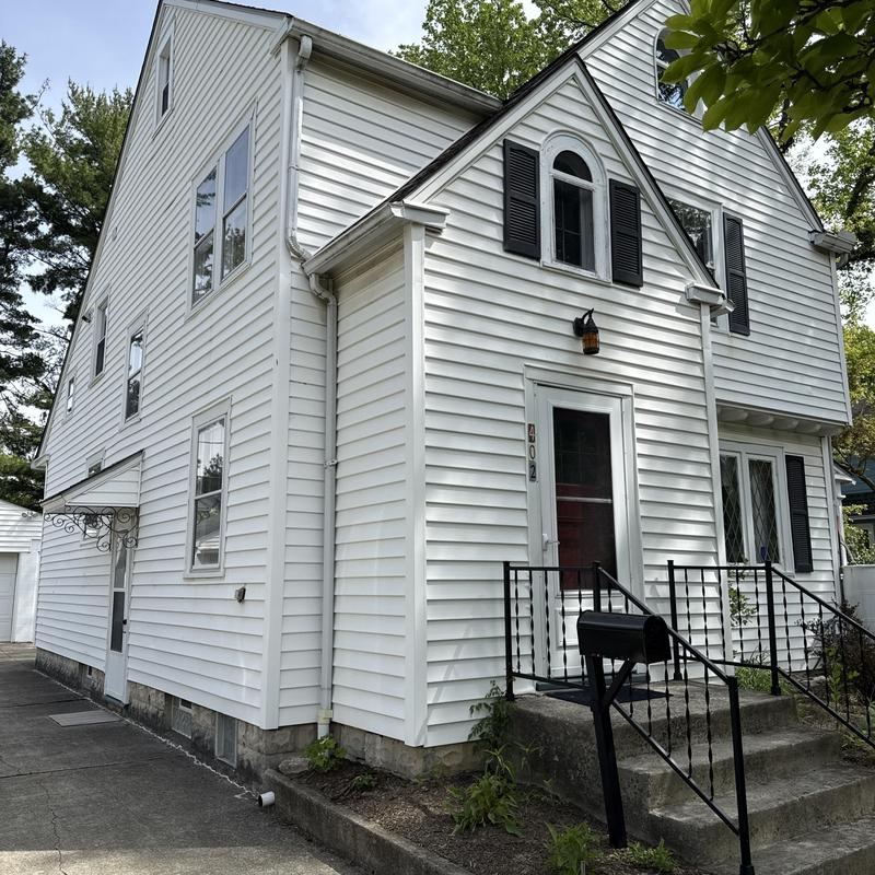 Vinyl siding replacement on two-story house exterior