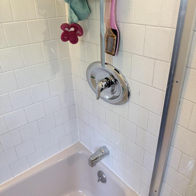 3-handle shower valve and tub spout in white tile shower 3-handle shower valve and tub spout in white tile shower