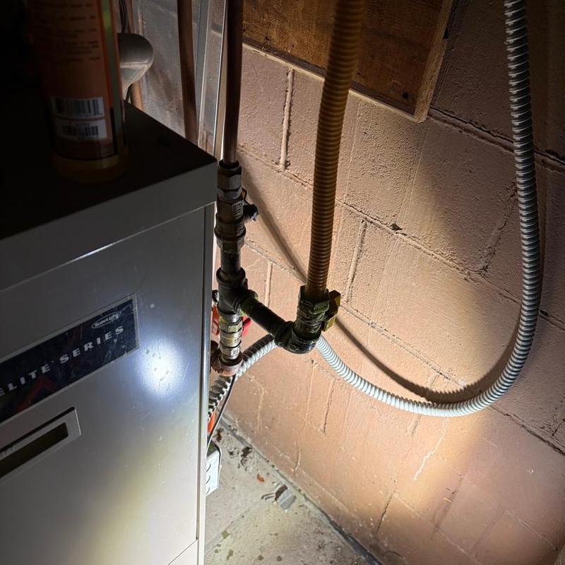 Gas line and furnace connection in basement corner