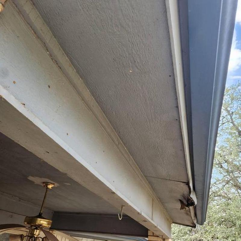 Soffit and fascia damage on home exterior near roofline