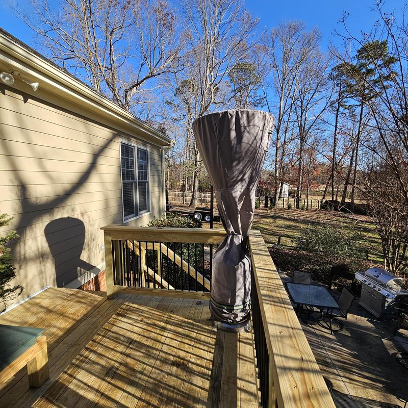 Wooden deck with railing and outdoor heater cover