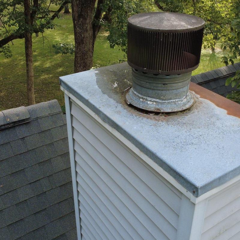 Chimney cap and metal flashing inspection on roof edge