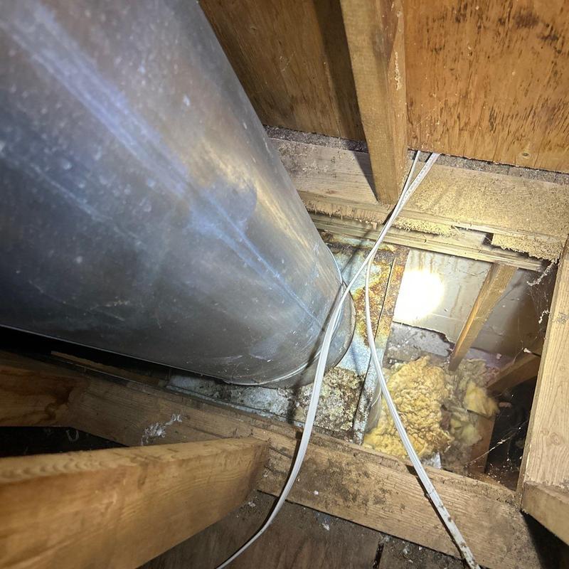 Metal chimney flue installation in attic space
