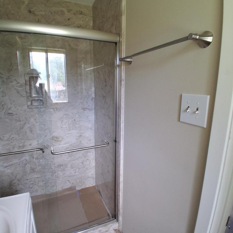 Towel rack and shower door installation in bathroom