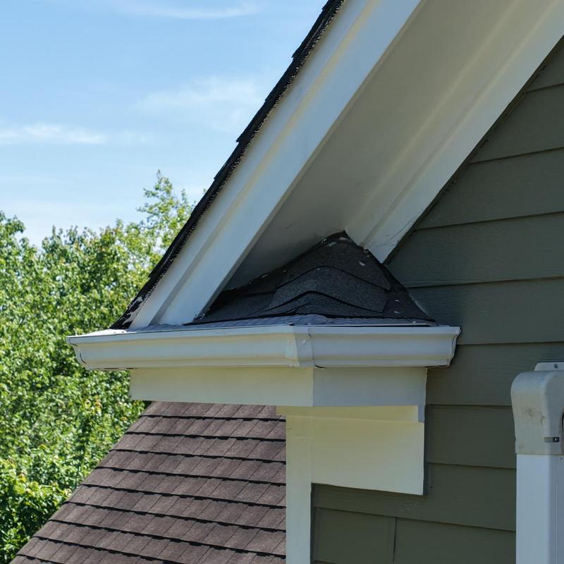 Roof flashing and gutter at angled dormer roof section