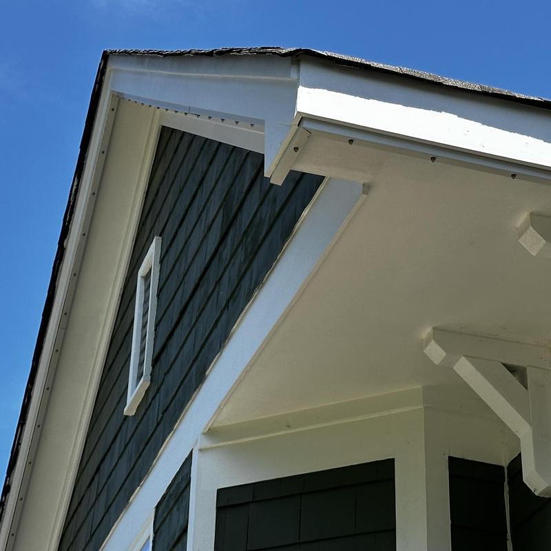 Roof fascia and soffit inspection on house corner