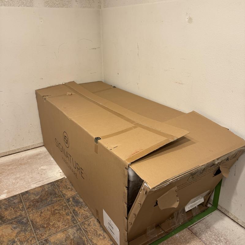 Freestanding tub in cardboard box for bathroom remodel