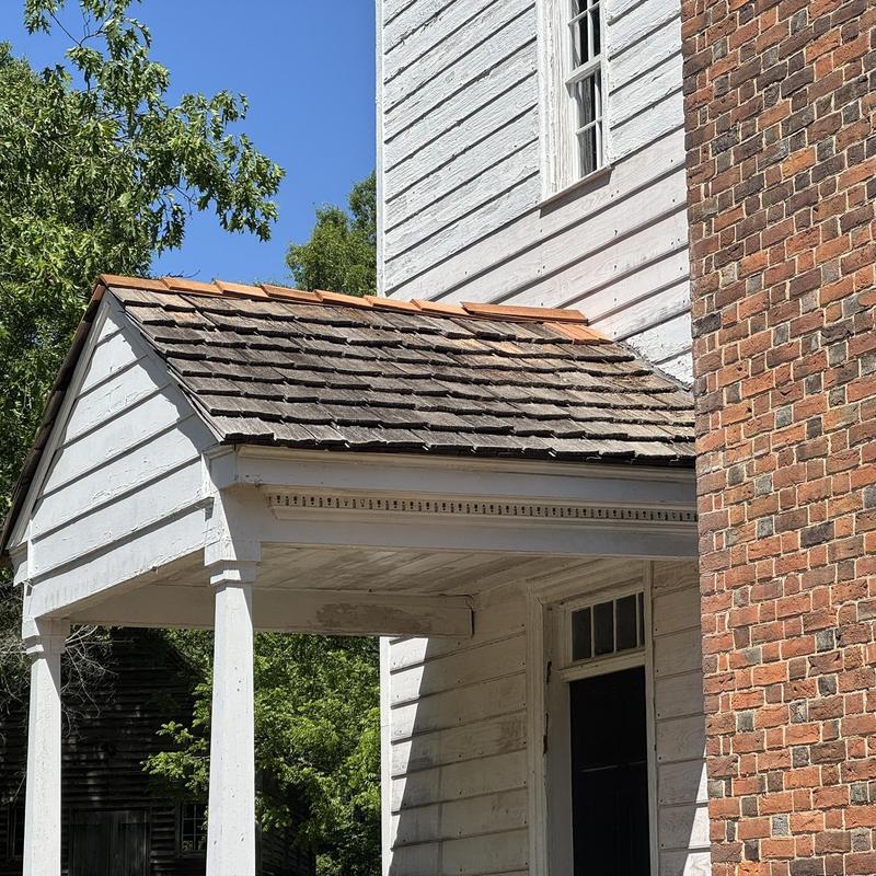 Cedar shake porch roof with flashing and wood repairs