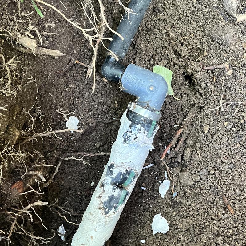 Irrigation line with connector and wrap in soil