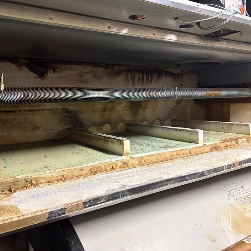 Heat exchanger coil inside central plant laundry unit with rust